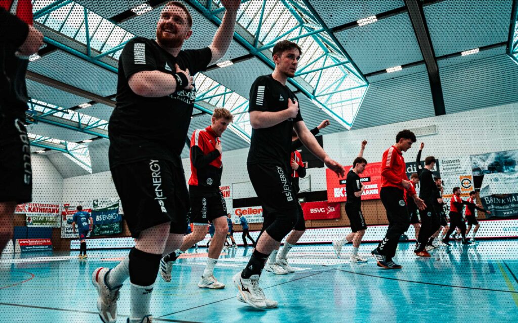 a group of men in black uniforms on a court